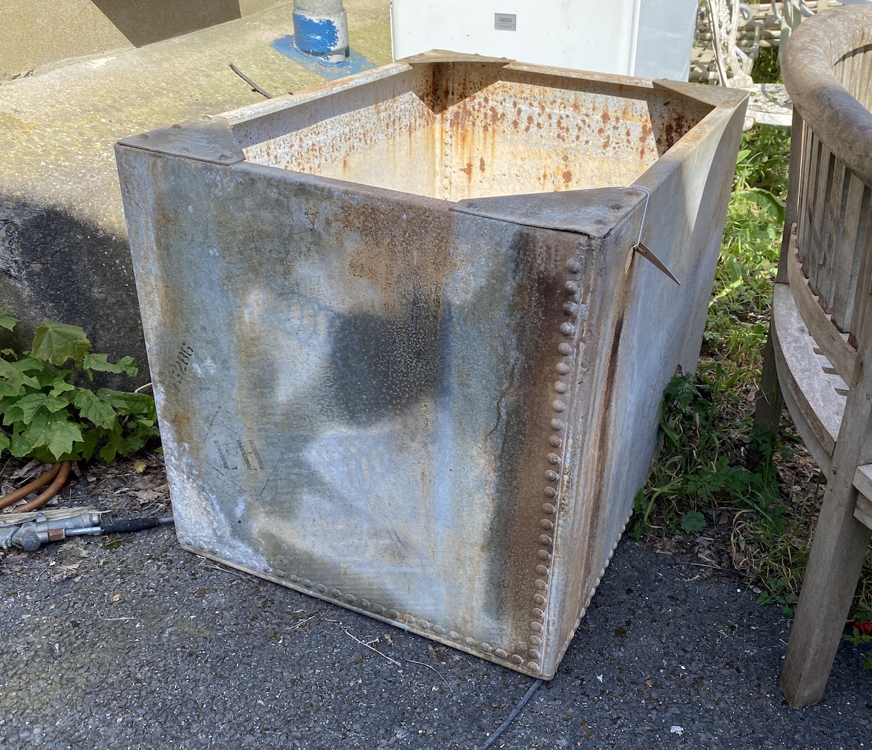 A rectangular riveted galvanised water tank, width 94cm, depth 67cm, height 69cm